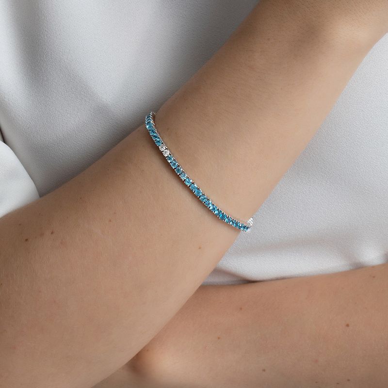 Pulseira-riviera-em-ouro-branco-com-topazios-azuis-e-topazios-brancos